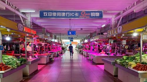 新城市场重新粉刷停车线，城管站岗指导停车